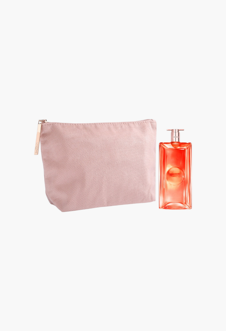 GLAM MODA Lancôme Idôle Peach 'N Roses perfume bottle next to a pink textured cosmetic pouch