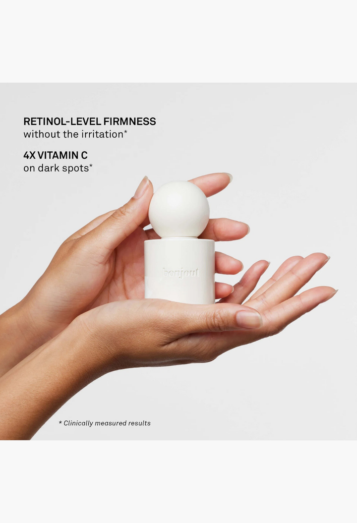 GLAM MODA La Cream skin longevity crème held in hands, featuring a minimalist white cylindrical jar with a round cap.