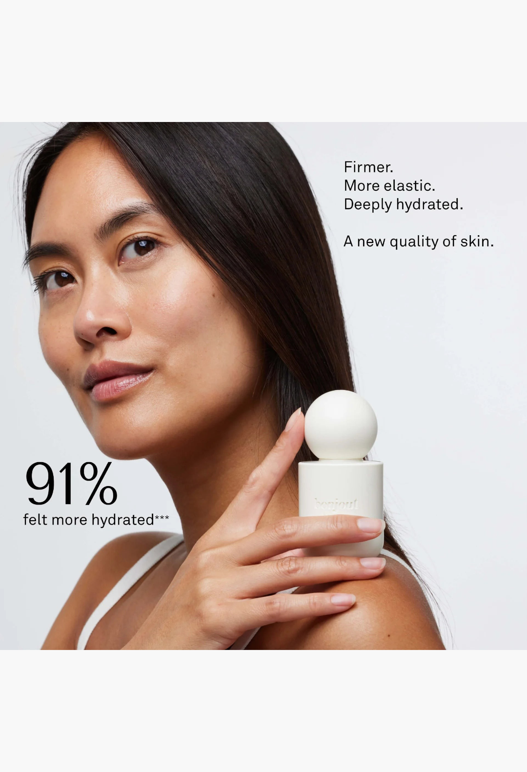 GLAM MODA model holding a white cylindrical La Cream skin longevity crème bottle with a spherical cap.