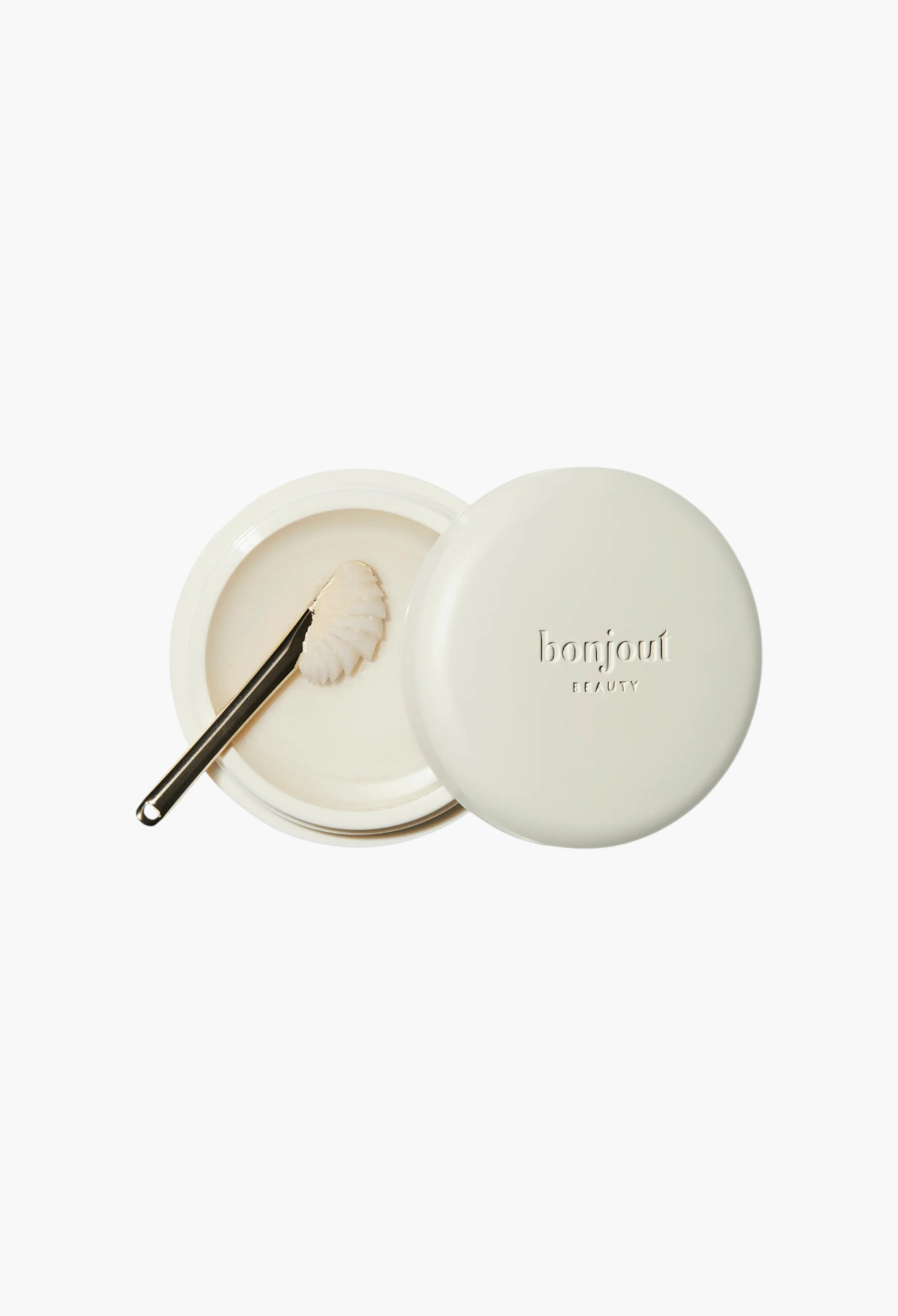 GLAM MODA Le Balm Trois unscented solid serum in a cream-colored jar with a small applicator spoon