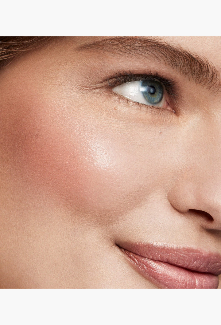 GLAM MODA Baby Cheeks Blush Stick applied to a model's cheek for a natural, flushed-from-within pink glow.
