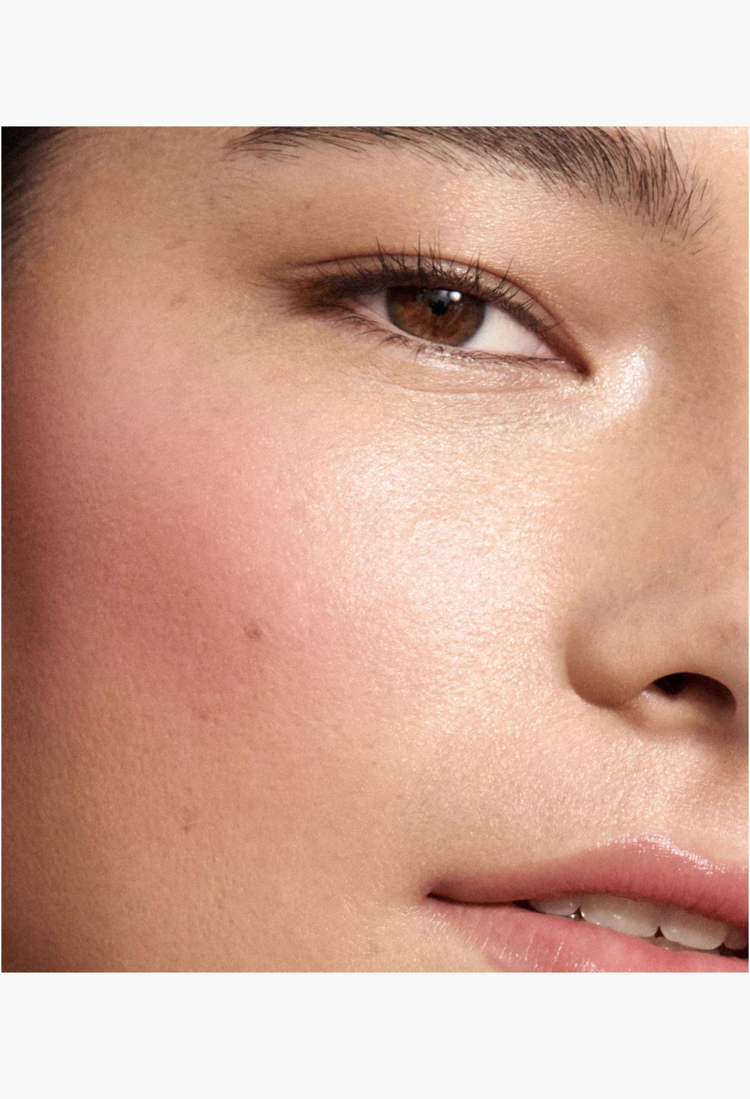 GLAM MODA Baby Cheeks Blush Stick applied to a model's cheekbone for a natural, flushed, and glowing finish.