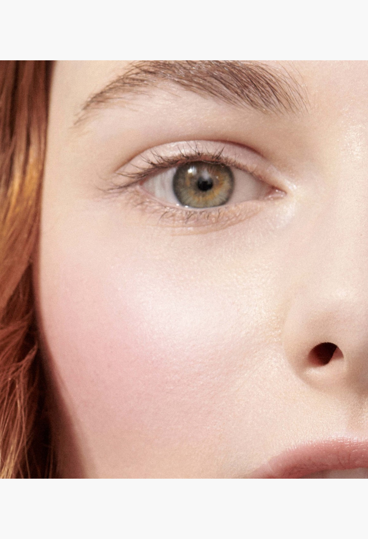 GLAM MODA Baby Cheeks Blush Stick applied to a model's cheek for a natural, flushed, and dewy makeup look.