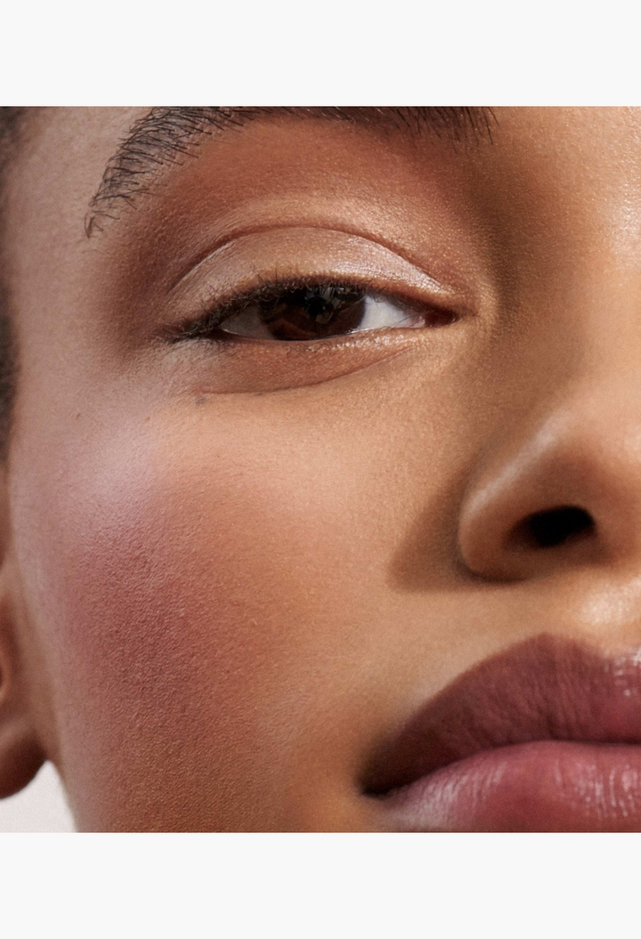 GLAM MODA Baby Cheeks Blush Stick applied to a model's cheek for a natural, flushed-from-within pop of color