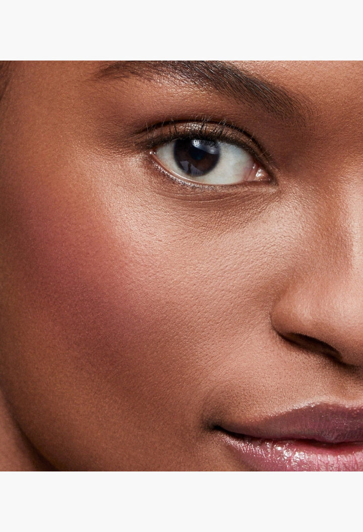 GLAM MODA Baby Cheeks Blush Stick applied to a model's cheek for a natural, flushed, and hydrated makeup look.