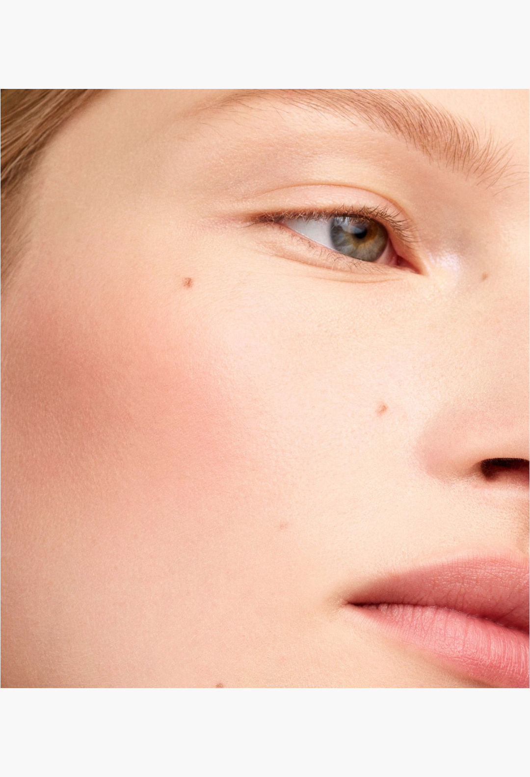GLAM MODA Baby Cheeks Blush Stick applied to a model's cheek for a natural, flushed-from-within pop of color