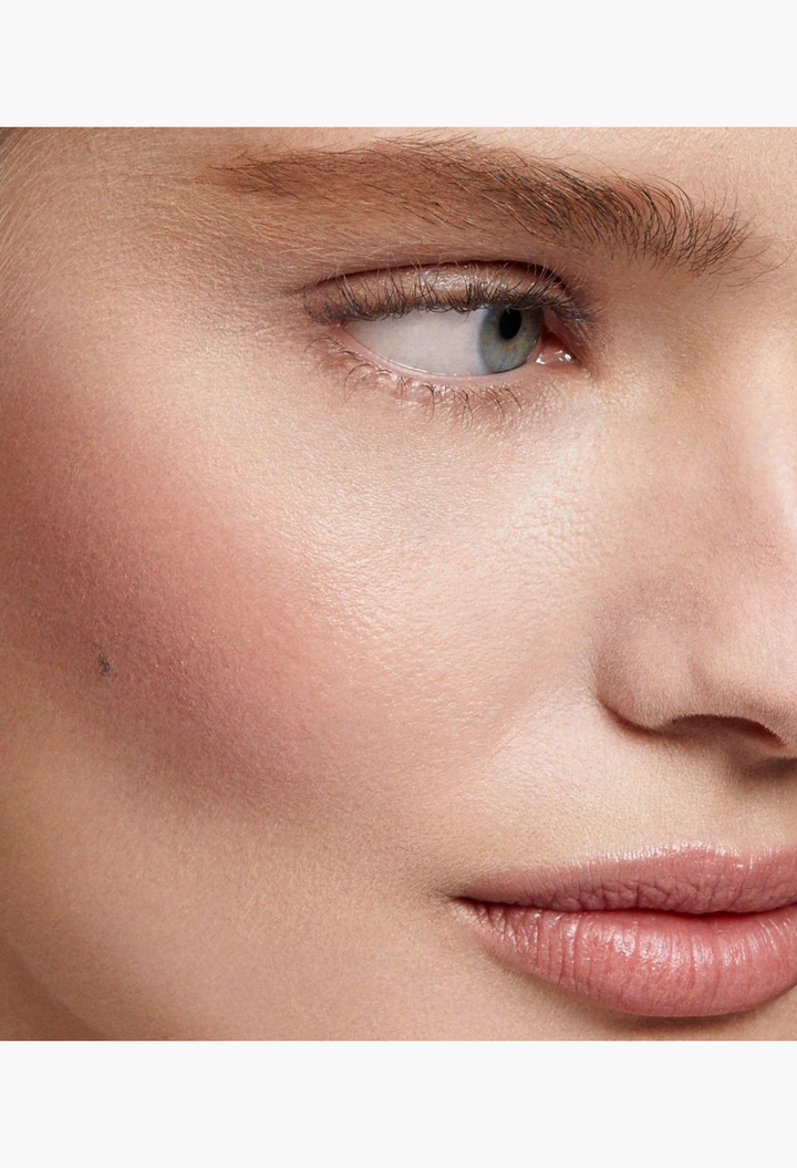 GLAM MODA Baby Cheeks Blush Stick applied as a creamy, blendable pigment on a model's cheek and lip for a natural glow.