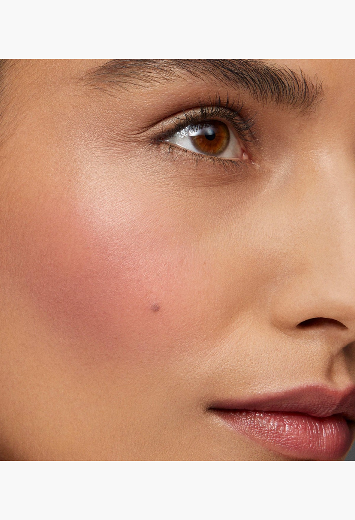 GLAM MODA Baby Cheeks Blush Stick applied to a model's cheek for a natural, flushed, and creamy makeup look.