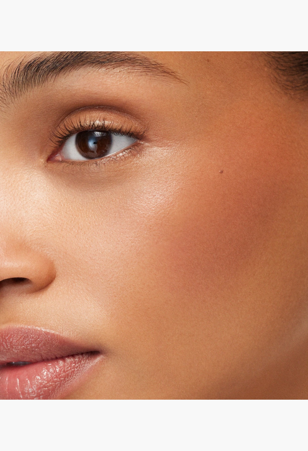 GLAM MODA Baby Cheeks Blush Stick applied as a soft pink cream on a model's cheek for a natural flushed look