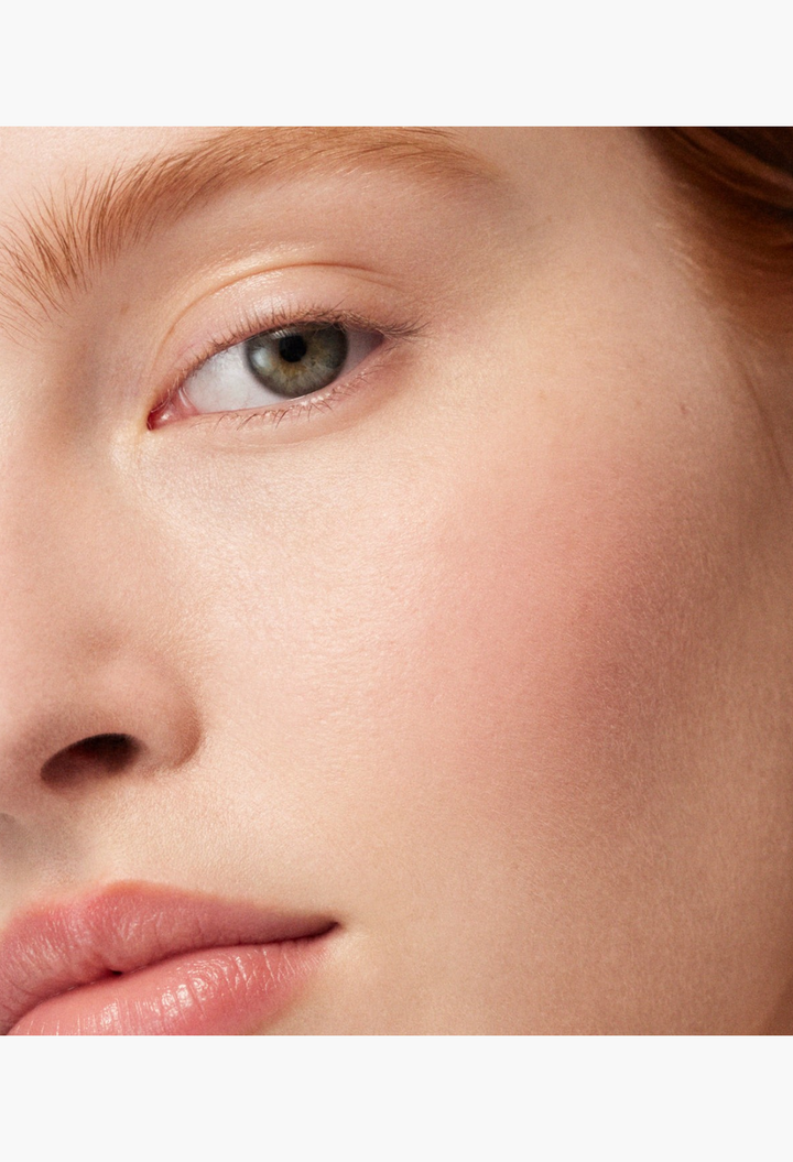 GLAM MODA Baby Cheeks Blush Stick applied to a model's cheek for a natural, flushed-from-within glow