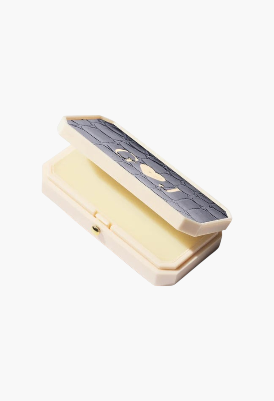 GLAM MODA Baume des Muses Ivory lip balm in a rectangular case with a textured grey lid and gold initial embossing.