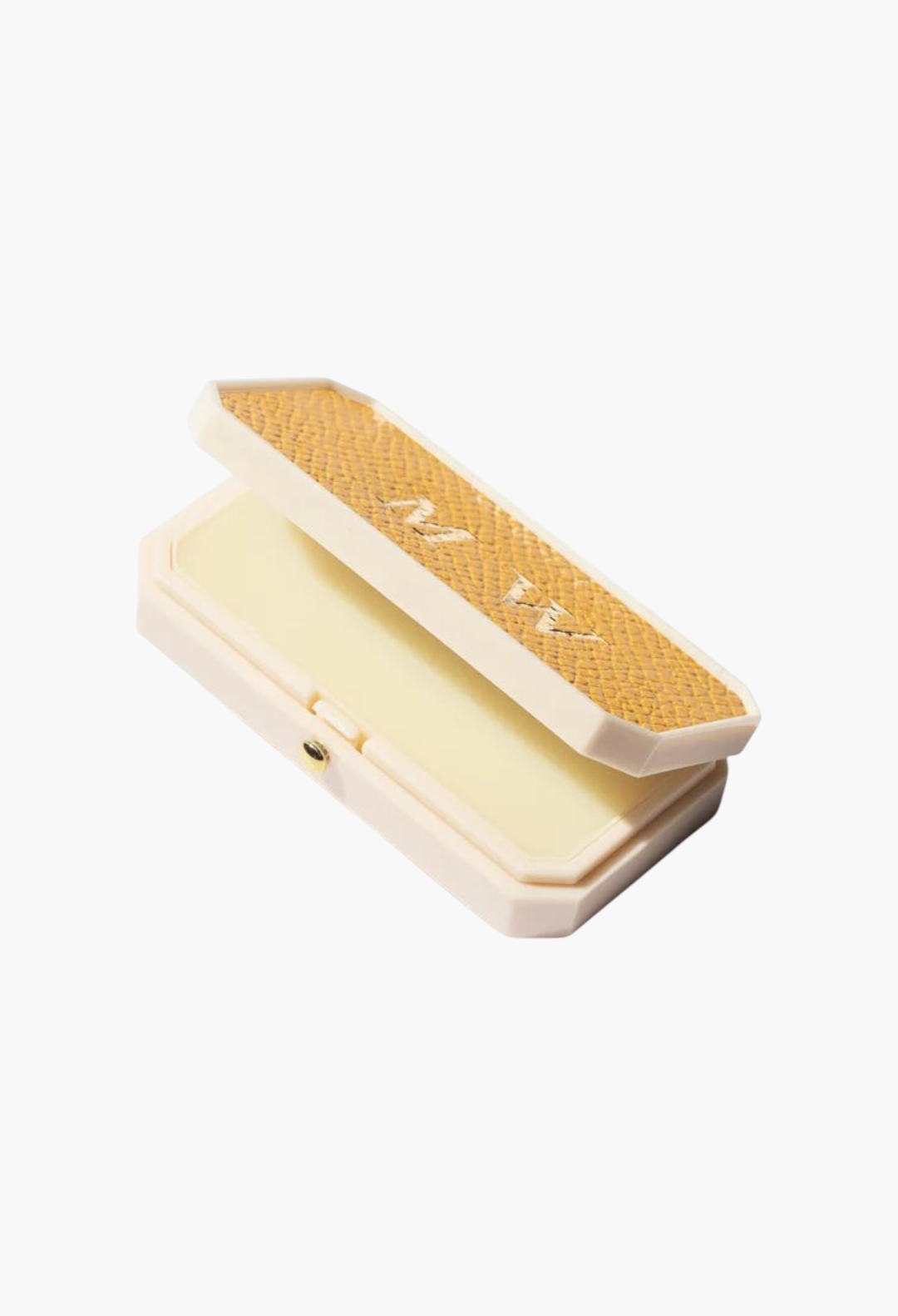 GLAM MODA Baume des Muses Ivory lip balm in a cream-colored case with a textured gold lid and embossed initials.