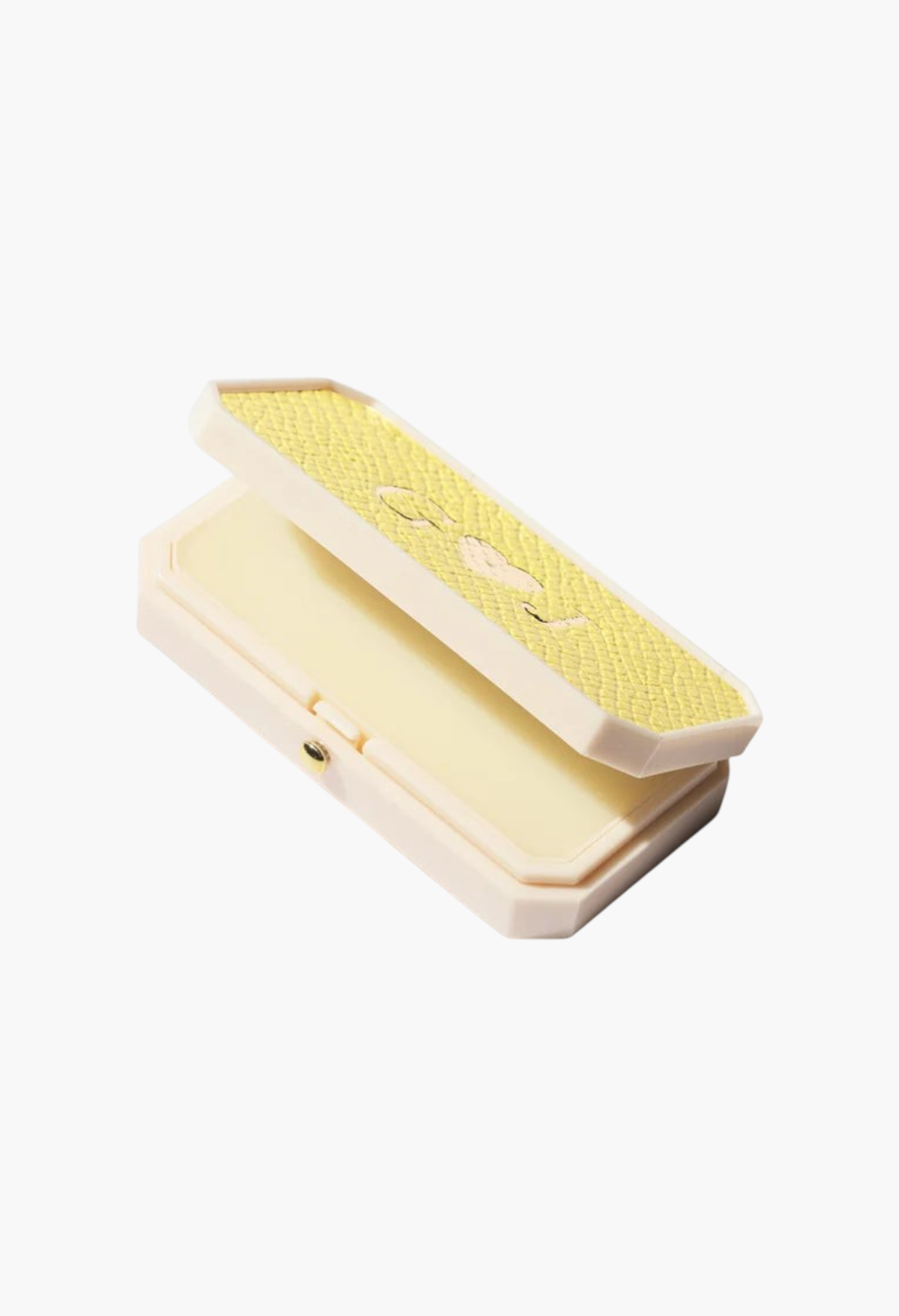 GLAM MODA Baume des Muses Ivory lip balm in an elegant, textured yellow and cream compact case on a white background.