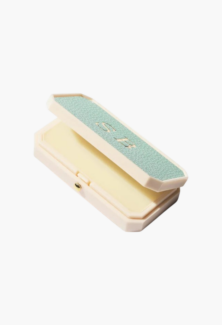 GLAM MODA Baume des Muses Ivory lip balm in a textured mint green and cream case with gold embossed initials