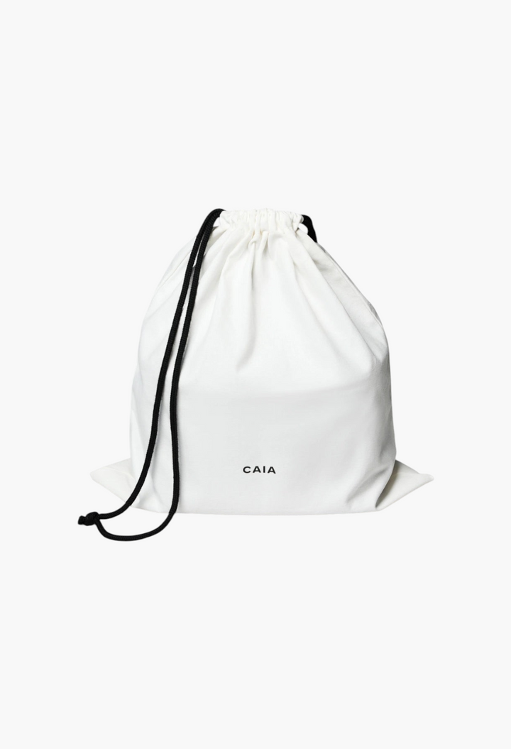 GLAM MODA white drawstring dust bag with black cords and CAIA logo branding for beauty case storage
