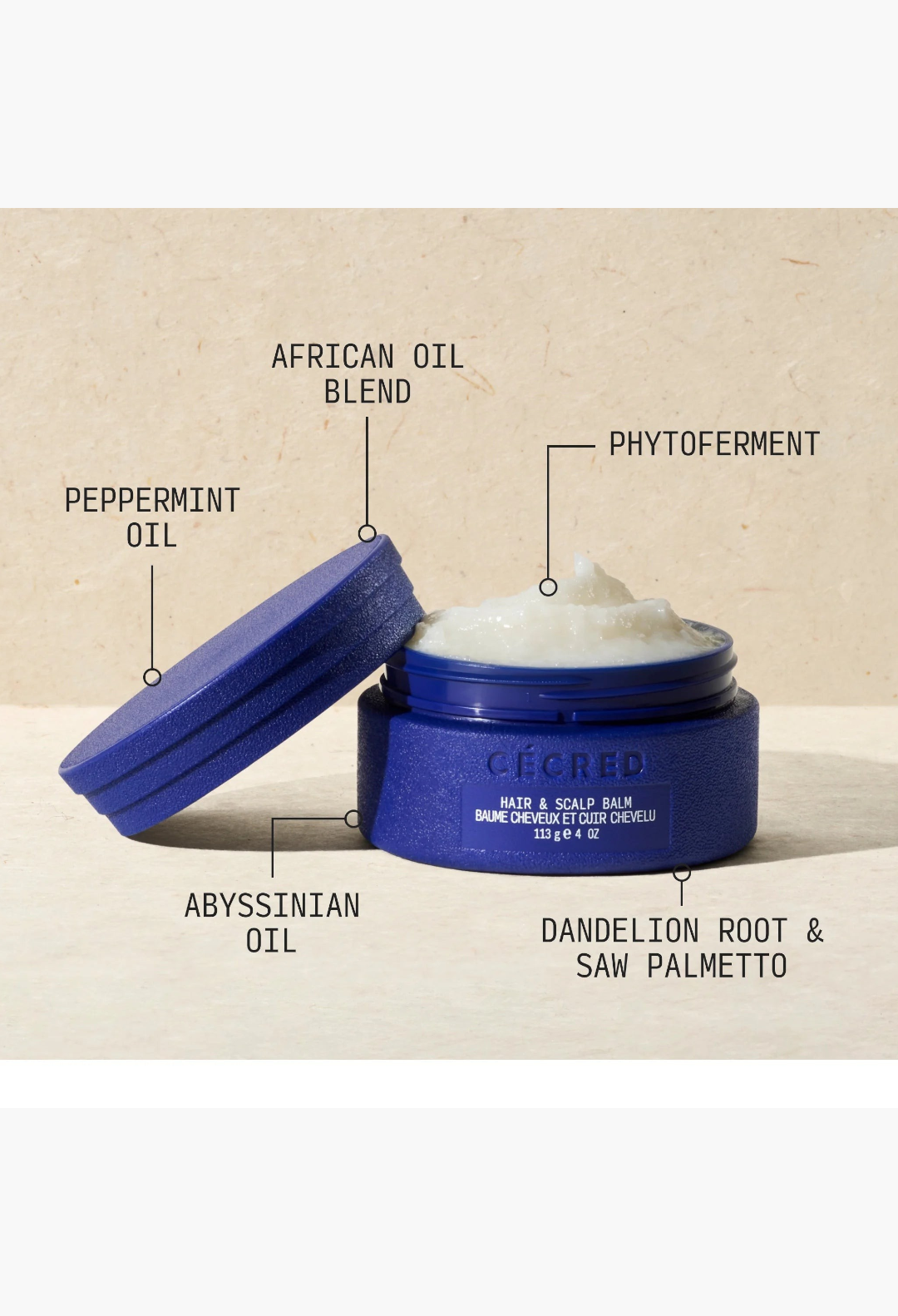 GLAM MODA Hair & Scalp Balm in a blue jar with ingredients labeled including peppermint oil and abyssinian oil.