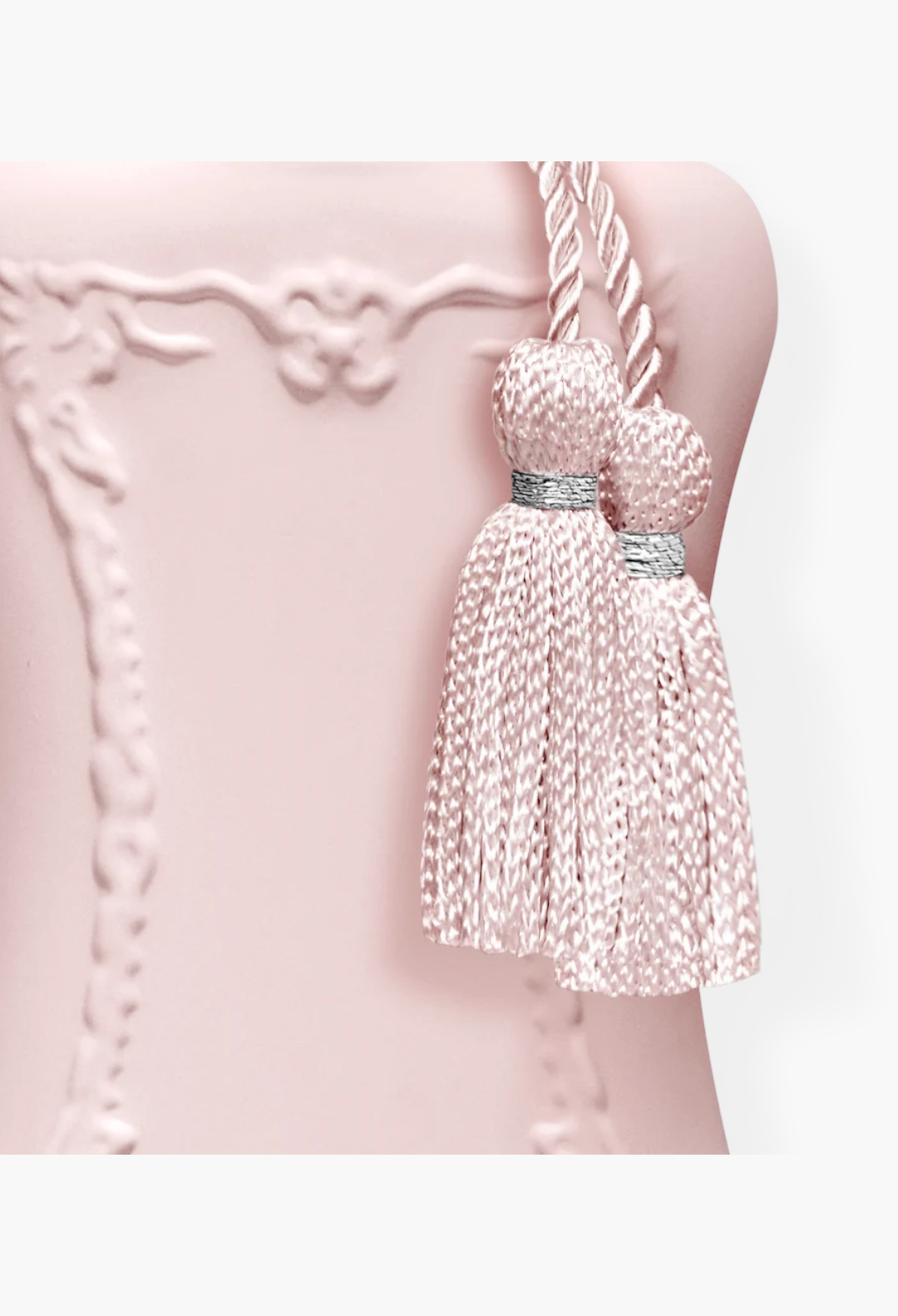 GLAM MODA Delina perfume bottle in matte pastel pink with decorative silk tassels and silver accents