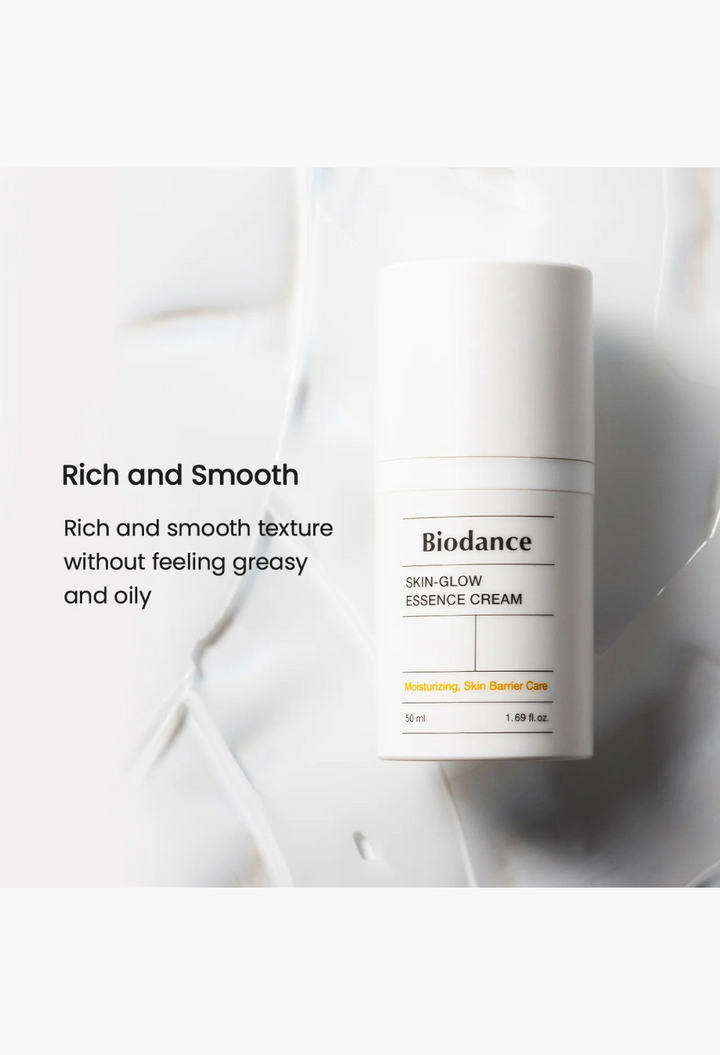 GLAM MODA Skin Glow Essence Cream in a white bottle with a smooth, rich moisturizing cream texture background.