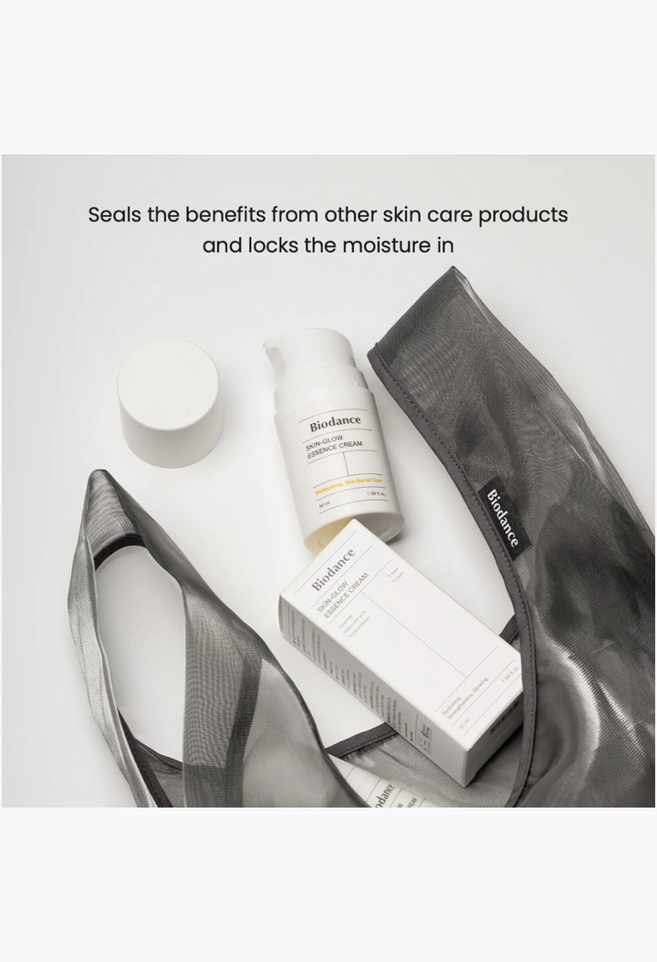 GLAM MODA Skin Glow Essence Cream bottle and box with a sheer grey mesh bag for hydrating skincare routine