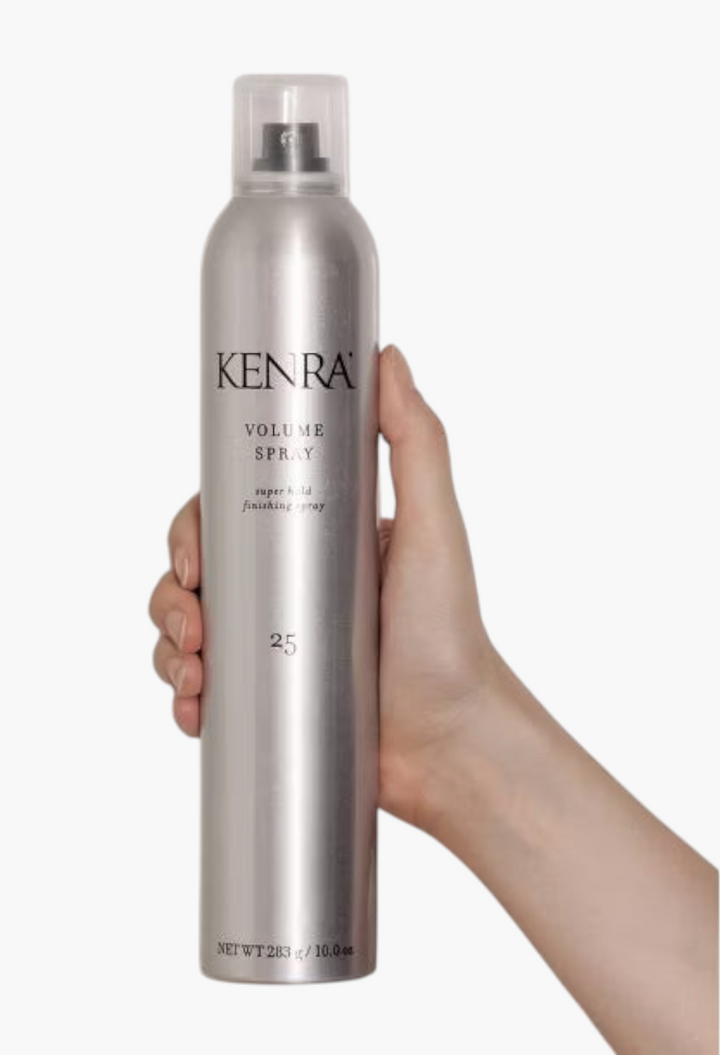 GLAM MODA Kenra Volume Spray 25 super hold hair finishing spray in a silver 10oz aerosol can held by a hand