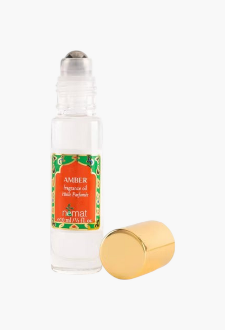 GLAM MODA Nemat Amber fragrance oil roll-on bottle with a gold cap, featuring a warm musky scent in a 10ml size.