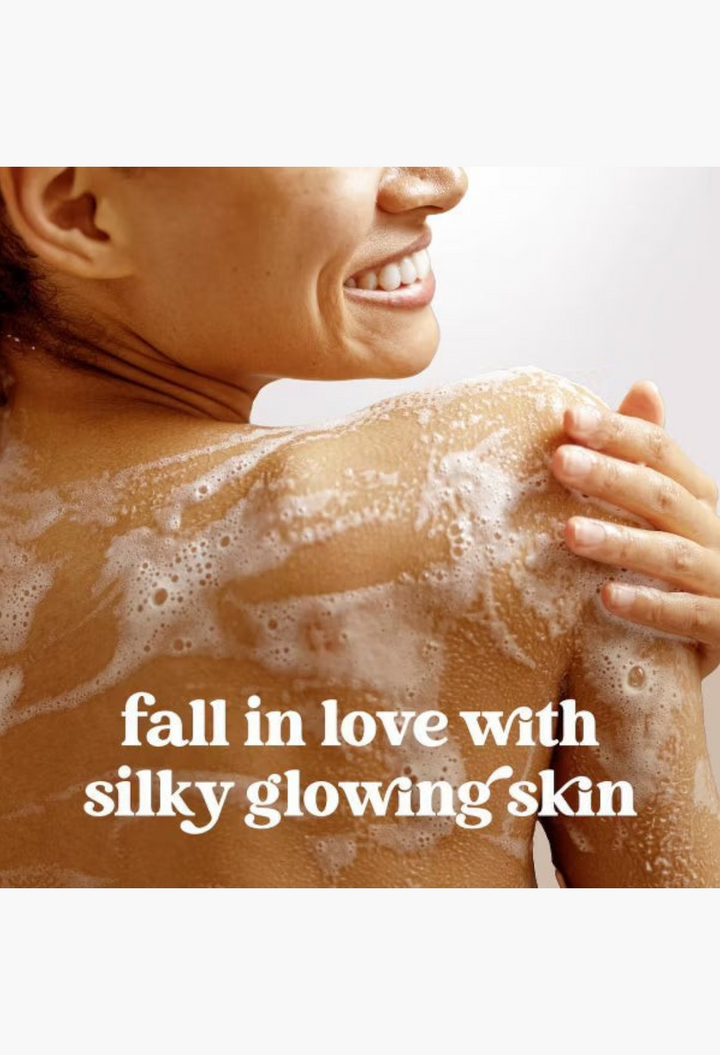 GLAM MODA Dove Cinnamon Pumpkin Pie body wash lathered on a woman's glowing shoulder for soft skin