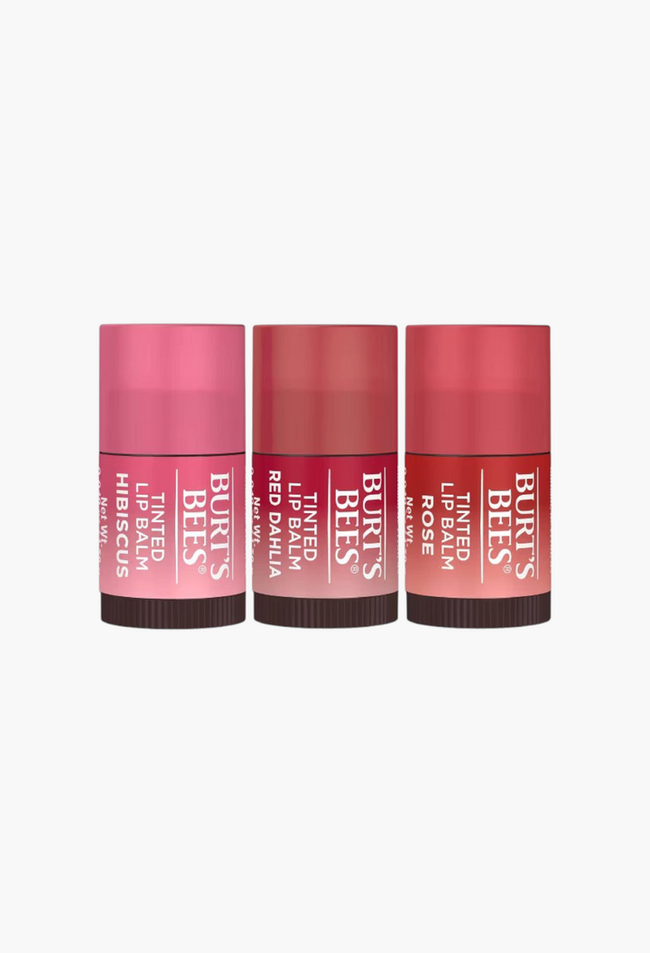 GLAM MODA Burt's Bees tinted lip balm set featuring Hibiscus, Red Dahlia, and Rose shades in mini tubes.