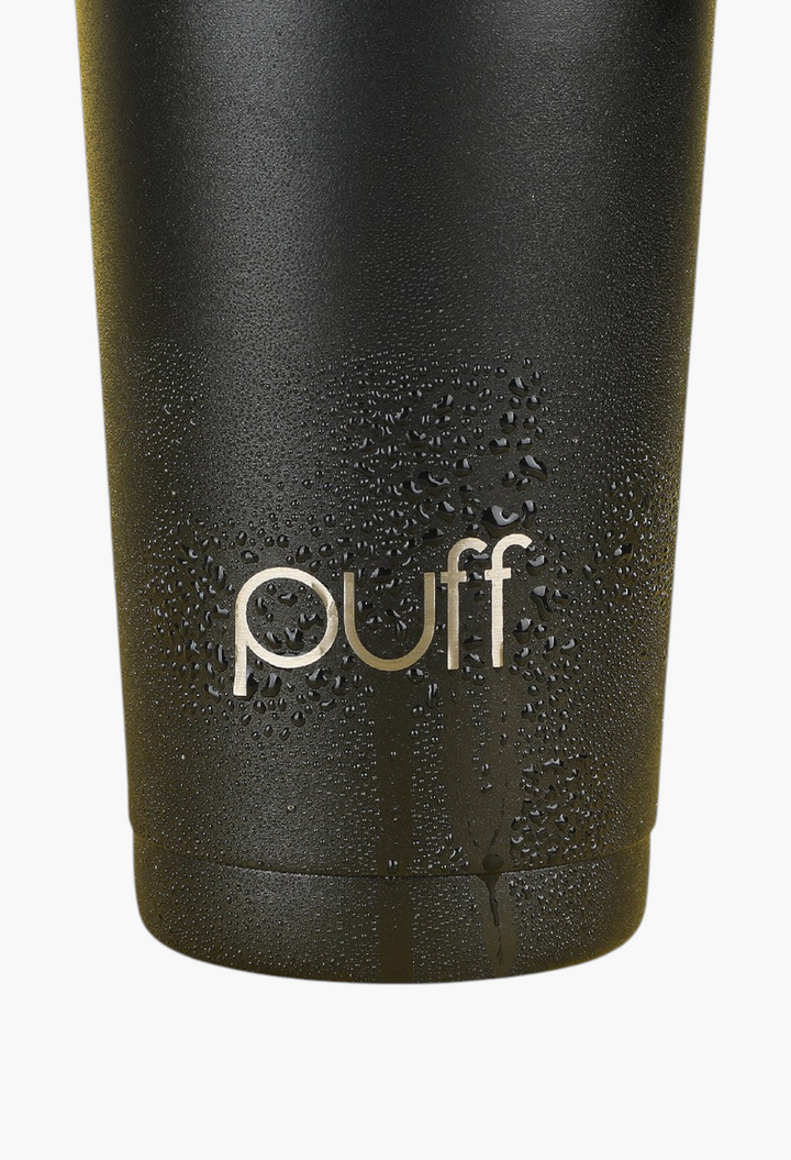 GLAM MODA matte black stainless steel Puff Shaker bottle with condensation droplets against a yellow background