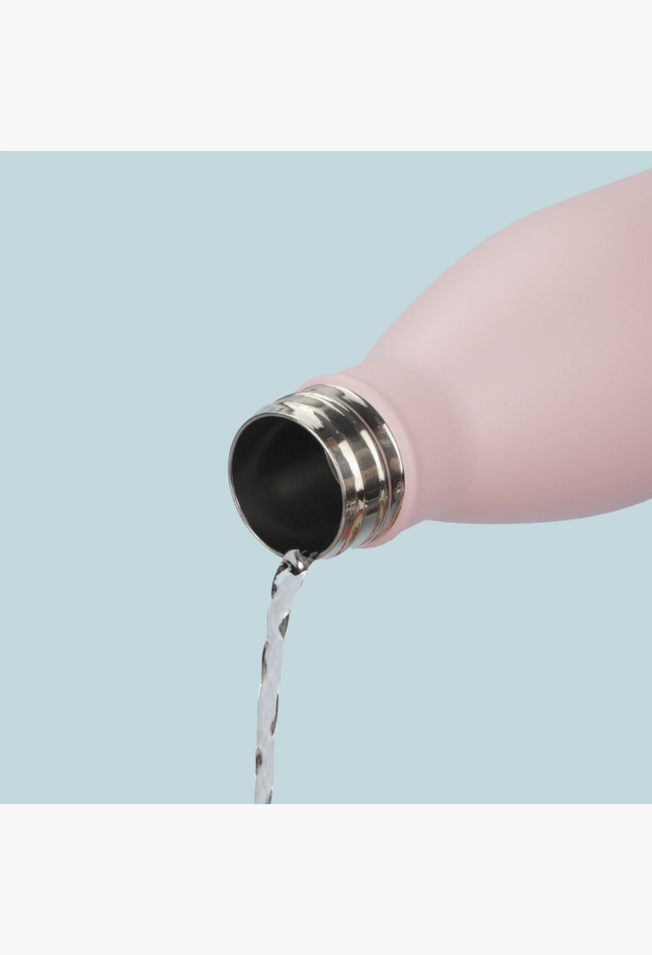 GLAM MODA matte baby pink stainless steel insulated water bottle pouring water from a wide drip-free opening