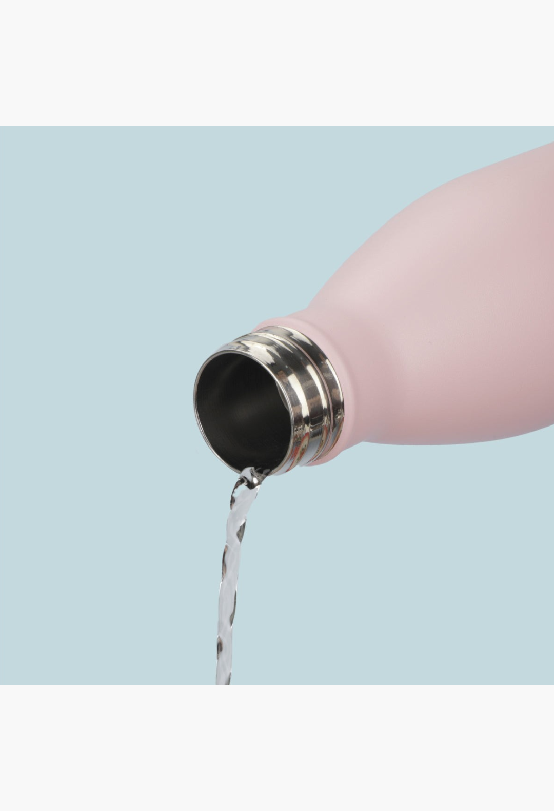 GLAM MODA matte baby pink stainless steel insulated water bottle pouring water from a wide drip-free opening
