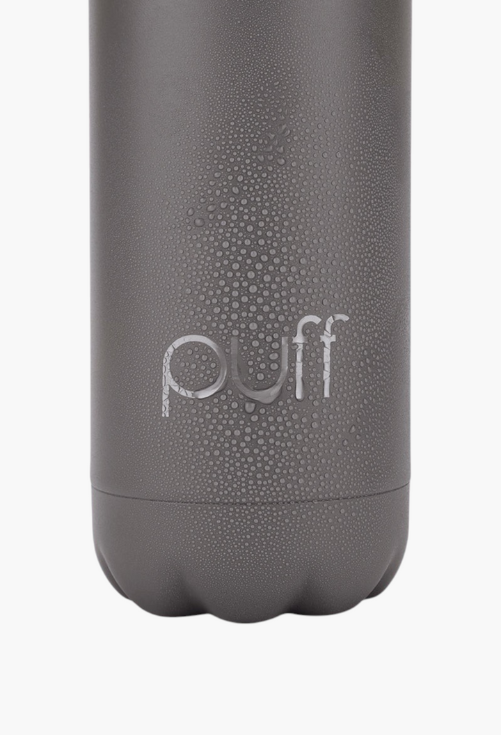 GLAM MODA matte volcanic grey stainless steel Puff bottle with condensation droplets on a light blue background