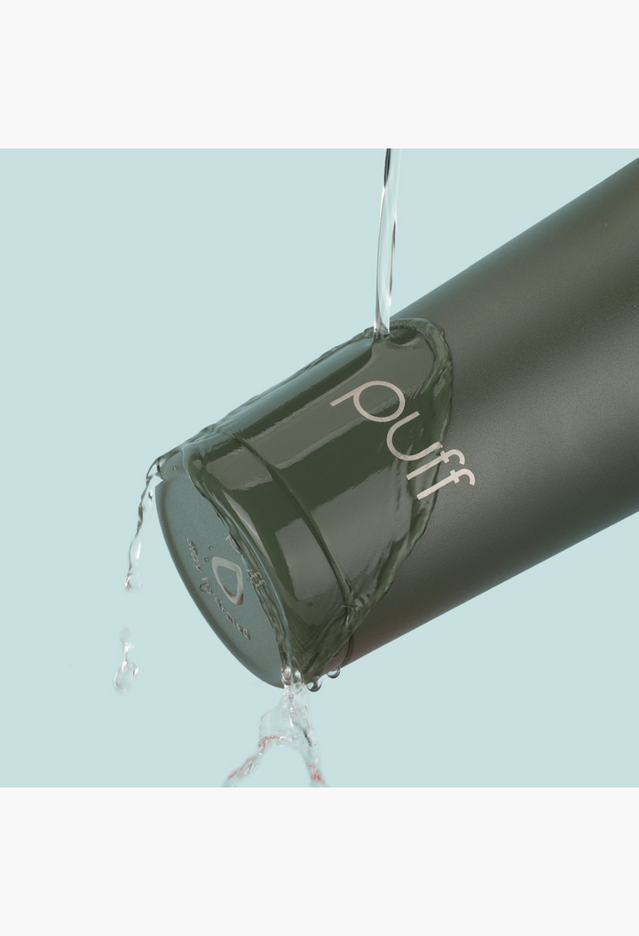 GLAM MODA Matte Shaker in olive green stainless steel being rinsed with water, showing its condensation-free surface.