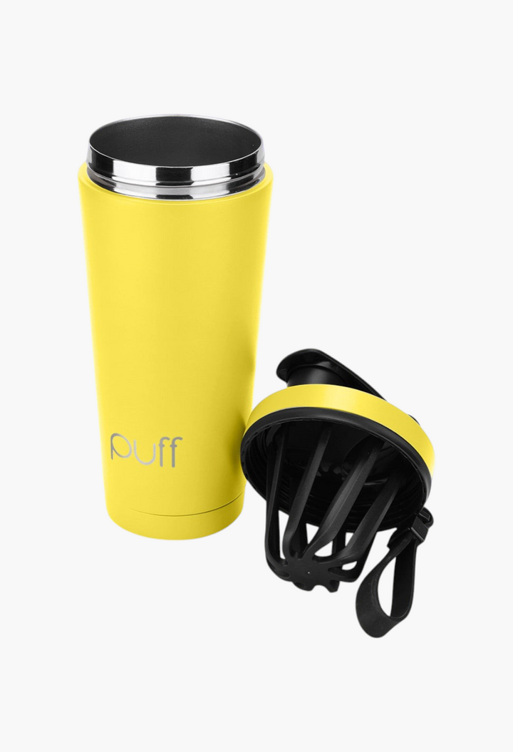 GLAM MODA yellow stainless steel insulated shaker bottle with a black lid and mixing whisk on a purple background.