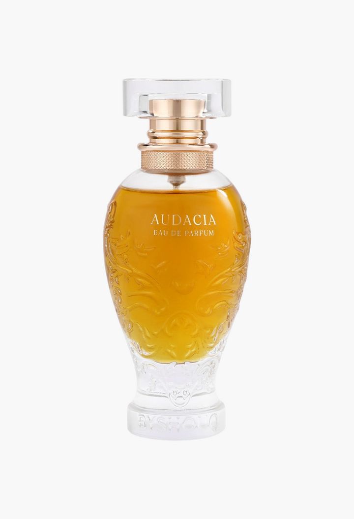 GLAM MODA Audacia woody eau de parfum in an ornate glass bottle with gold accents and embossed floral details.