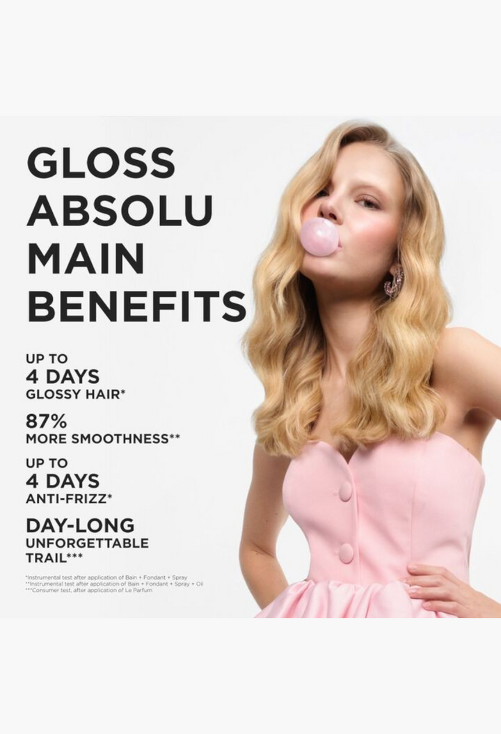 GLAM MODA Gloss Le Parfum hair perfume advertisement featuring a woman with wavy blonde hair blowing a pink bubble.