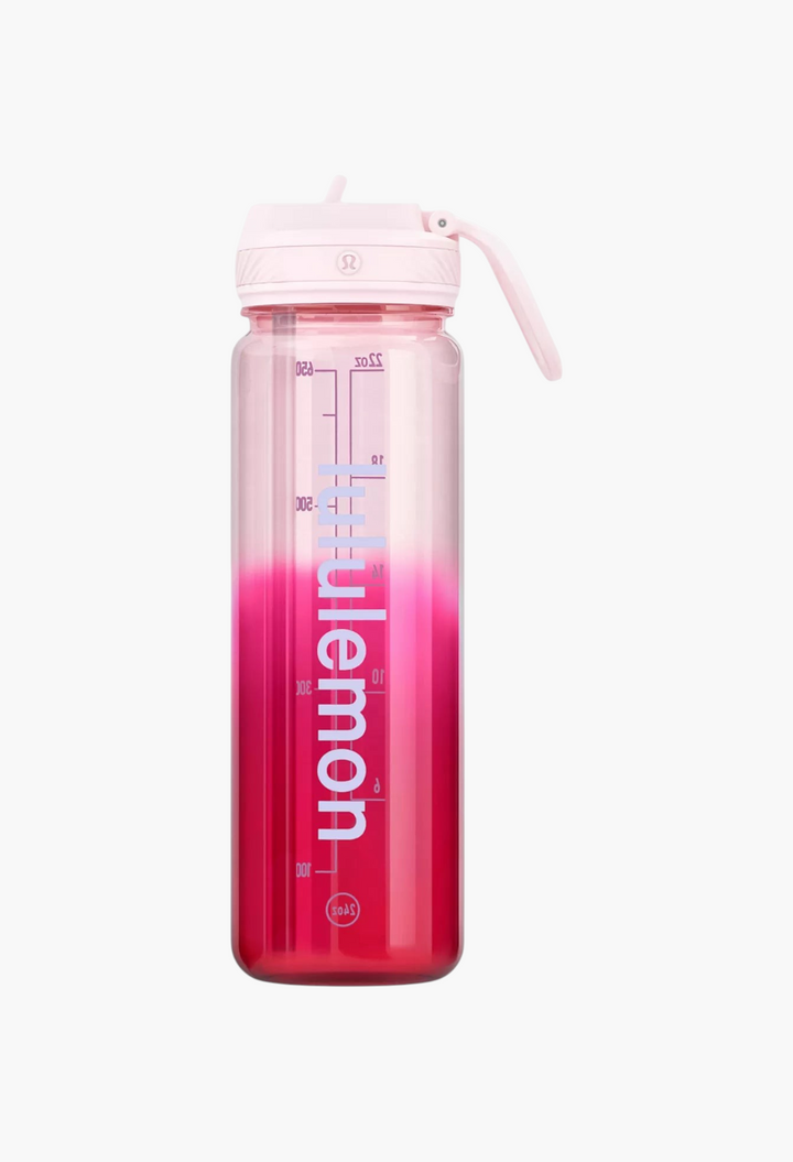 GLAM MODA Back to Life clear Tritan water bottle with a pink ombre finish, straw lid, and measurement markings.
