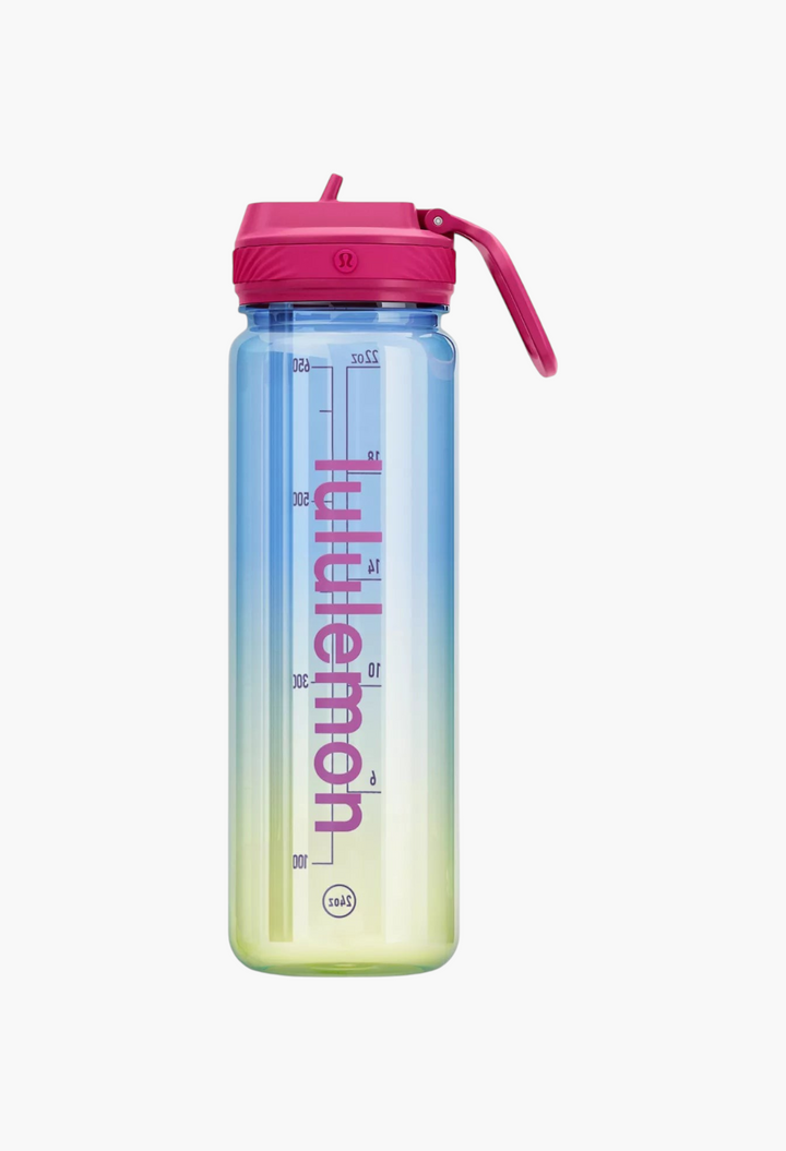 GLAM MODA 24oz clear water bottle with a pink straw lid, featuring a blue-to-yellow gradient and vertical branding.