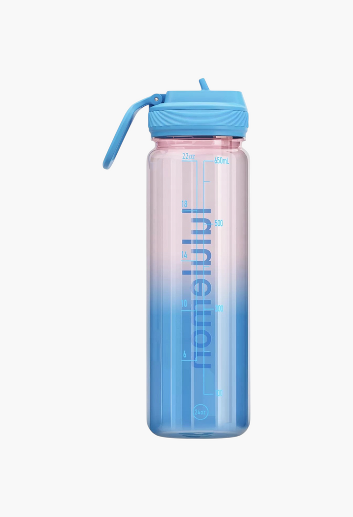 GLAM MODA 24oz clear water bottle with a blue straw lid and pink-to-blue gradient finish with volume markings.