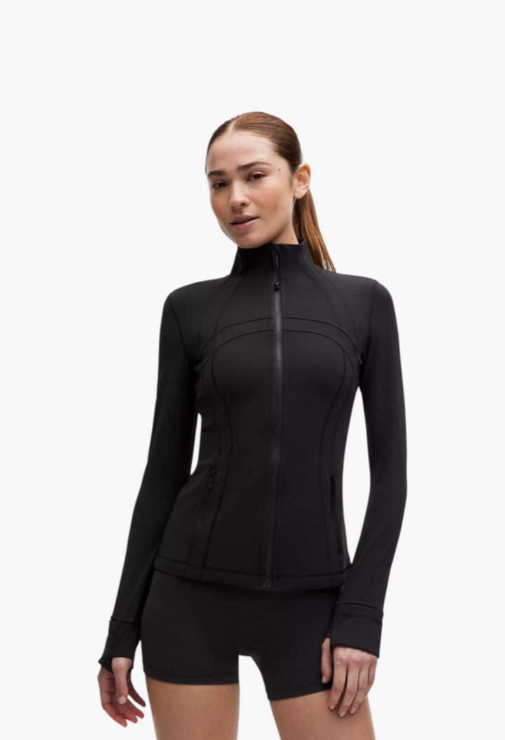 GLAM MODA Define Jacket in black Nulu fabric, featuring a slim fit, high collar, zippered pockets, and thumbholes.