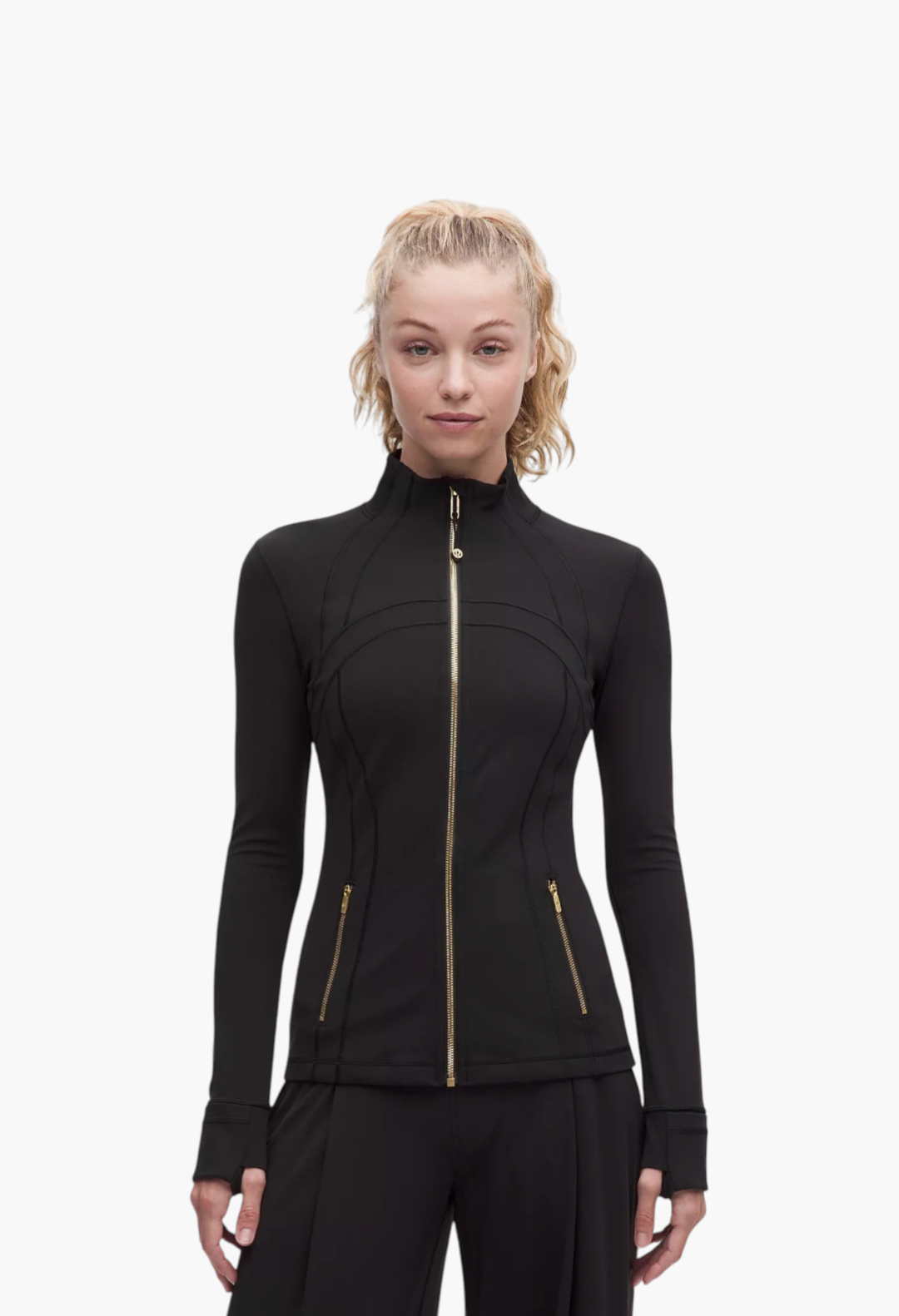 GLAM MODA Define Jacket Nulu in black with gold zippers, thumbholes, and a slim-fit athletic design on a model.