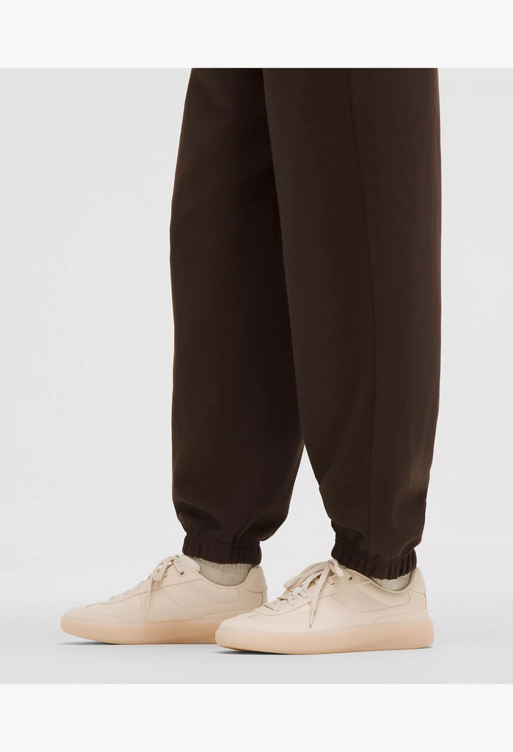 GLAM MODA Women's Cityverse sneaker in cream with leather-alternative upper, exposed stitching, and rubber outsole.
