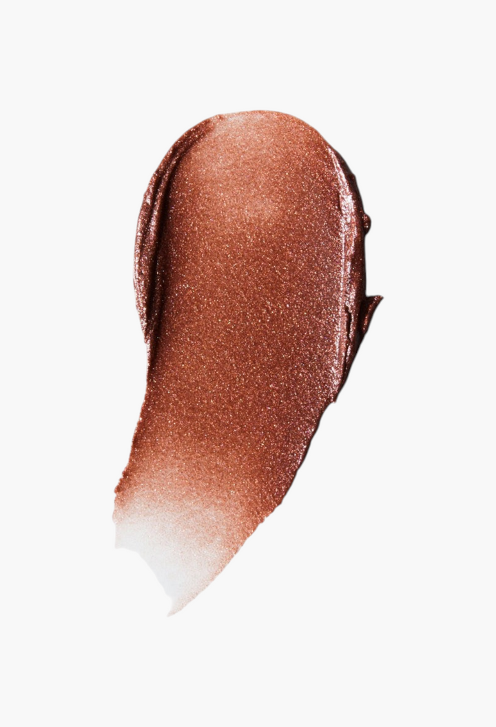 GLAM MODA Lit Up Highlight Stick swatch showing a shimmering bronze gel texture for a radiant glassy finish