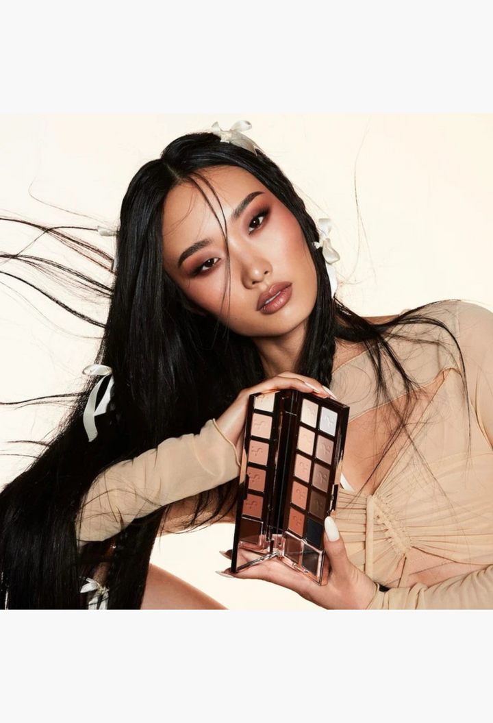 GLAM MODA Major Dimension III matte eyeshadow palette with warm and cool nude shades held by a model