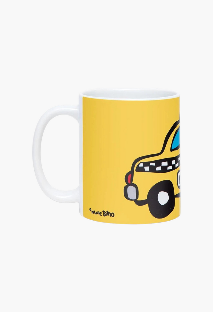 GLAM MODA ceramic 12oz coffee mug featuring a yellow NYC taxi illustration by artist Marc Tetro on a white background.
