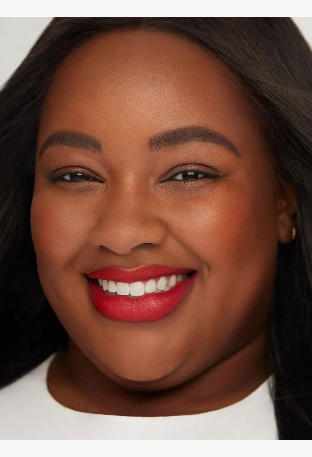 GLAM MODA Kind Words matte lip liner in Devoted true red shade applied on a smiling model with a soft matte finish