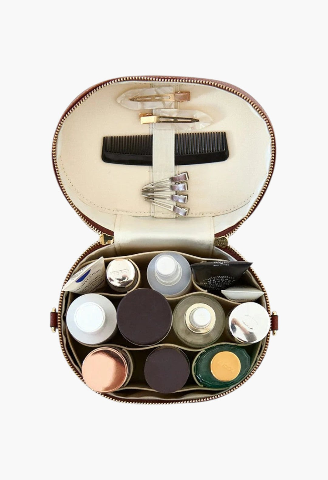 GLAM MODA oval vegan leather toiletry case with removable divider, elastic brush storage, and various beauty products.