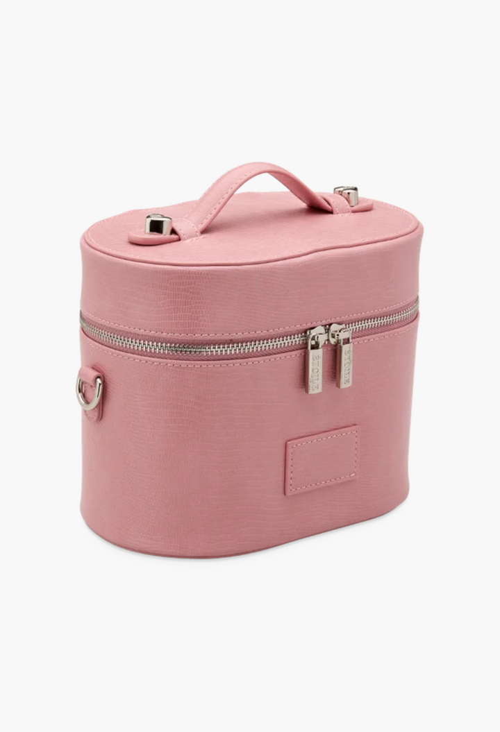 GLAM MODA pink oval vegan leather toiletry case with a top handle, dual zippers, and textured finish.