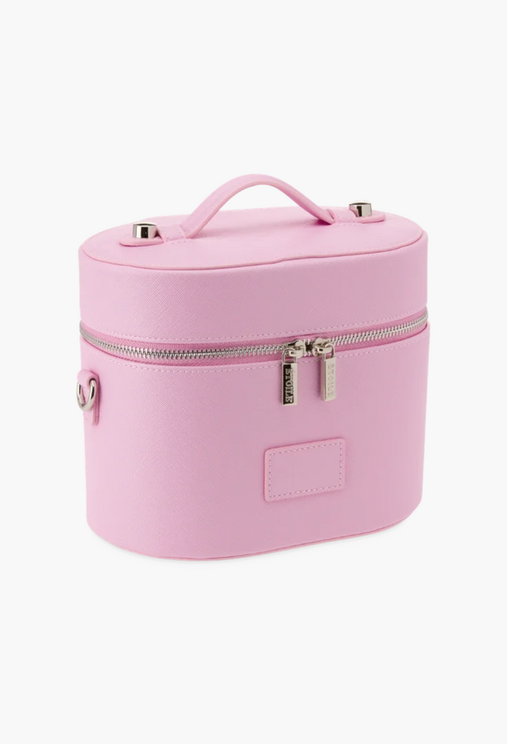 GLAM MODA oval toiletry case in soft pink vegan leather with a top handle, dual zippers, and a structured design.