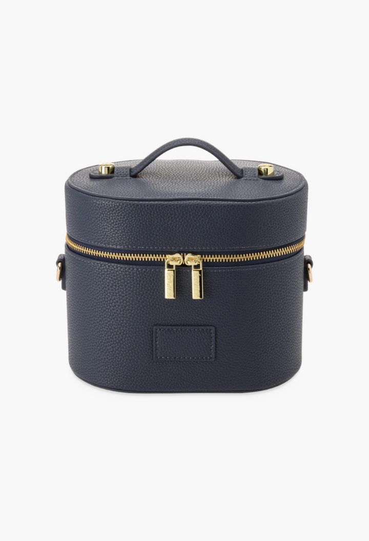 GLAM MODA navy blue vegan leather oval toiletry case with gold double zippers and a top carry handle.
