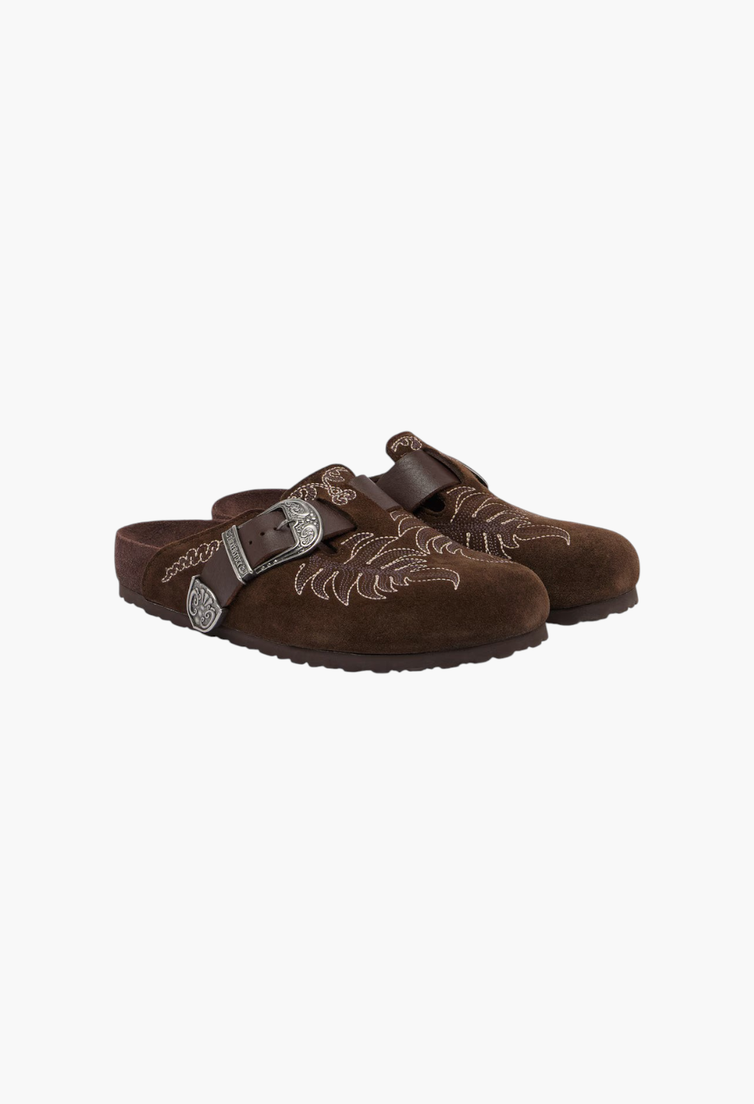 GLAM MODA Birkenstock Boston brown suede clogs with intricate white embroidery and engraved metal buckle detail.